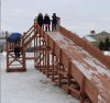 Деревянная горка уже встретила первых посетителей. Сколько радости, удовольствия и восторга на лицах довольных ребятишек