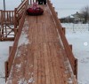 Деревянная горка уже встретила первых посетителей. Сколько радости, удовольствия и восторга на лицах довольных ребятишек